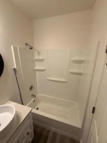 a bathroom with a bathtub and a toilet