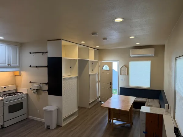 a kitchen with stainless steel appliances a refrigerator a stove a sink dishwasher and a stove with wooden floor