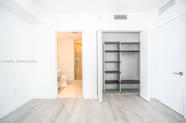 a view of a room with wooden floor