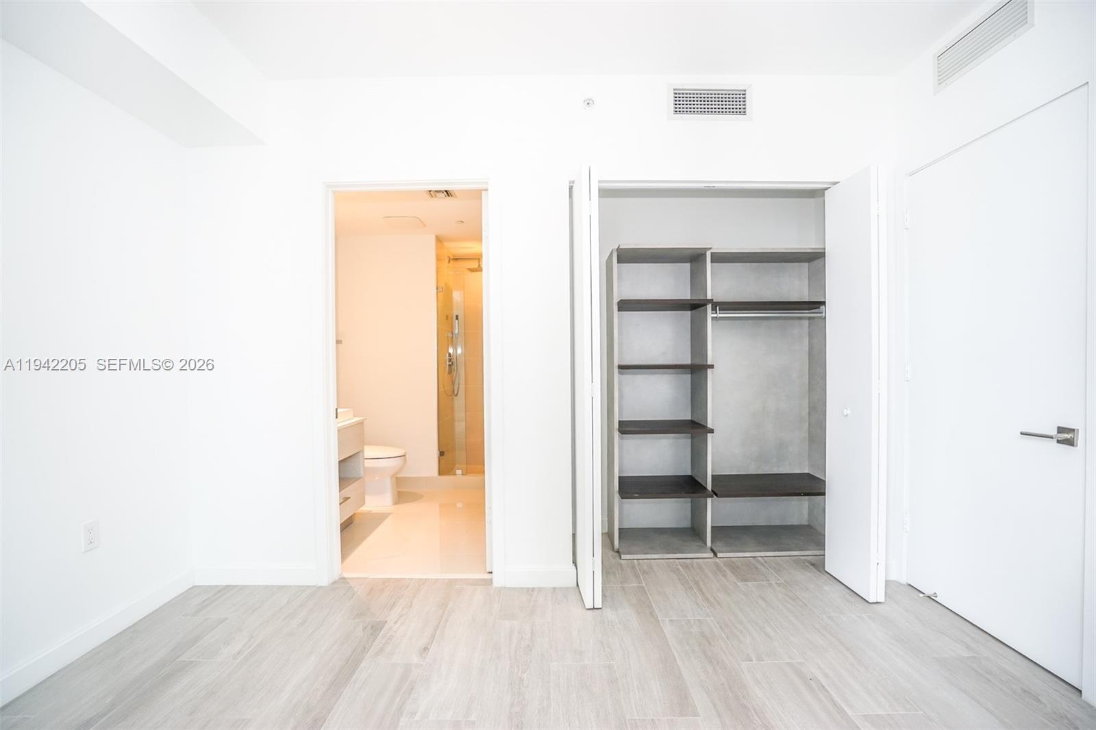 55 Southwest 9th Street, Unit 1407 Miami, FL 33130 - Photo 11 of 24 a view of a room with wooden floor