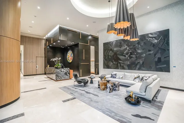 a living room with furniture and a floor to ceiling window