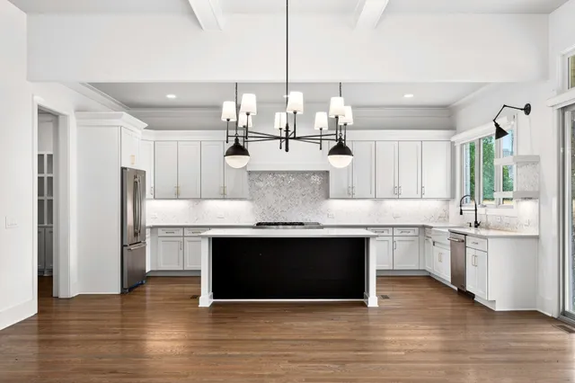 a view of an empty room with a fireplace and a large window