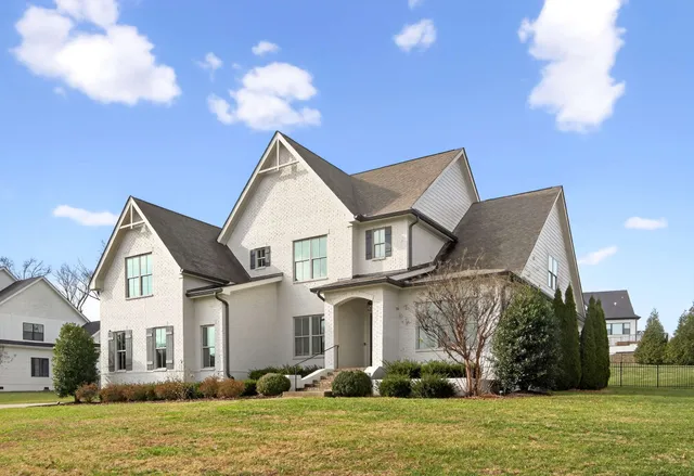 an empty room with wooden floor fireplace and window