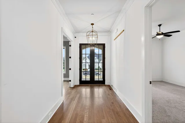 a view of kitchen with stainless steel appliances wooden floor sink stove and wooden floor