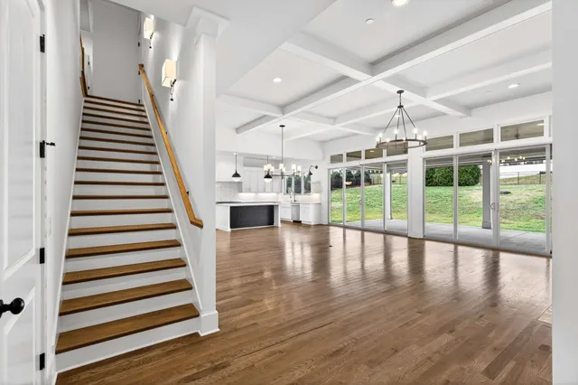 a kitchen with stainless steel appliances granite countertop a stove a sink and a wooden floors