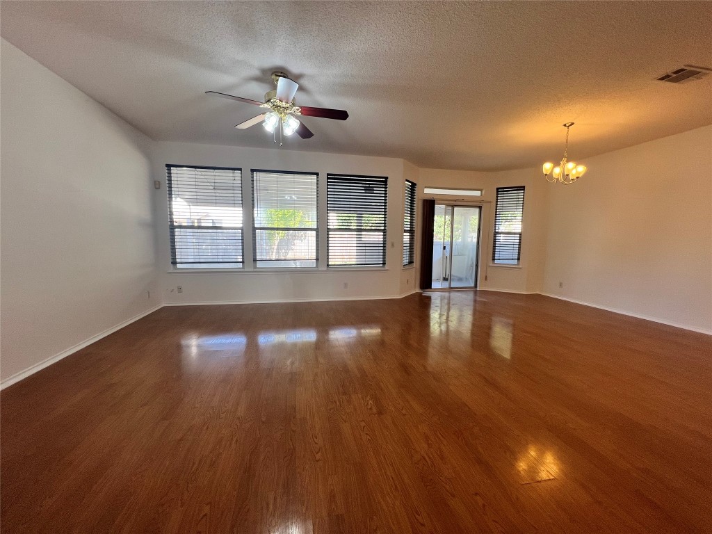 1525 Natural Bridge Lane Pflugerville, TX 78660 - Photo 4 of 15 a view of an empty room with wooden floor and a window