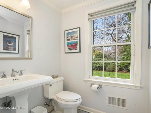 a bathroom with a tub a sink and mirror