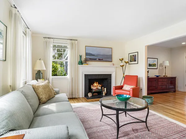 a living room with furniture fireplace and window