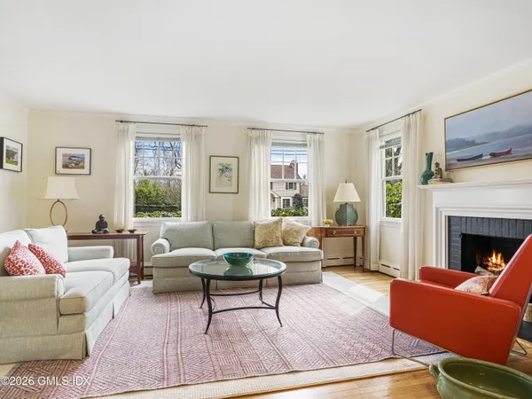 a living room with furniture dining area and a window