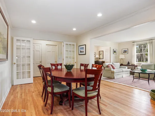 a dining room with furniture a fireplace and wooden floor