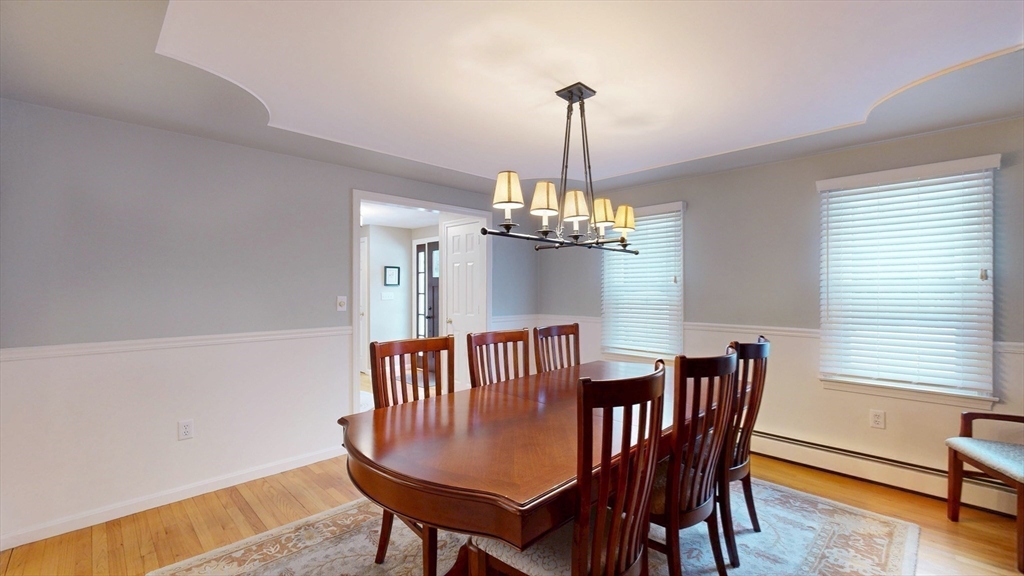 990 Forest Street North Andover, MA 01845 - Photo 12 of 42 a view of a dining room with furniture a chandelier and wooden floor