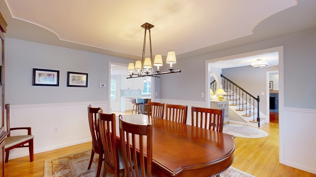 990 Forest Street North Andover, MA 01845 - Photo 13 of 42 a view of a dining room with furniture a chandelier and wooden floor