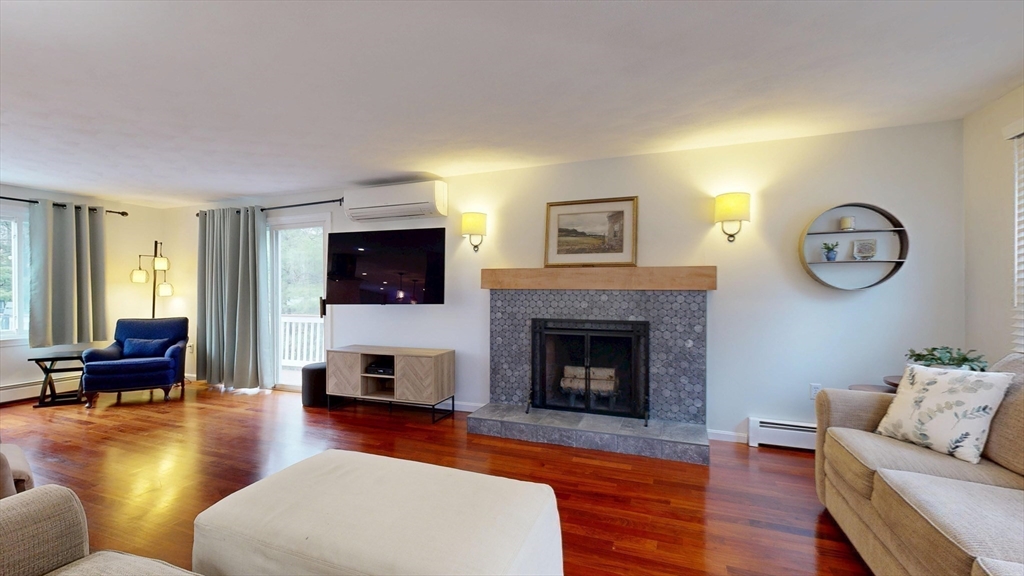 990 Forest Street North Andover, MA 01845 - Photo 23 of 42 a living room with furniture a flat screen tv and a fireplace