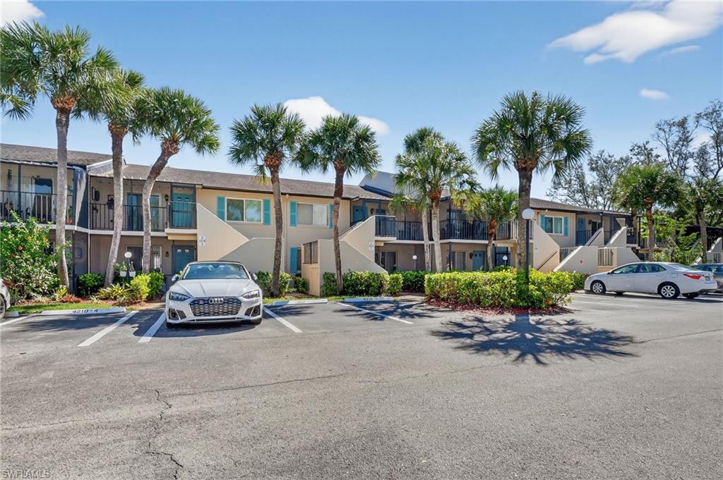 4210 Looking Glass Lane, Unit 4210 Naples, FL 34112 - Photo 1 of 20 a car parked in front of a house