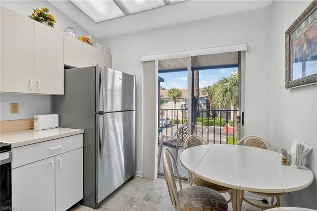 a kitchen with a refrigerator and a sink