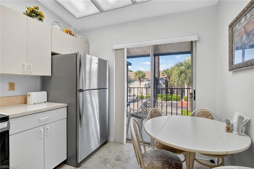 4210 Looking Glass Lane, Unit 4210 Naples, FL 34112 - Photo 12 of 20 a kitchen with a refrigerator and a sink
