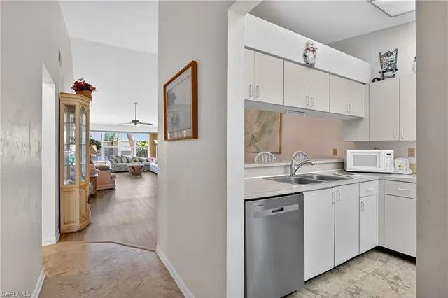 a kitchen with a sink cabinets and appliances