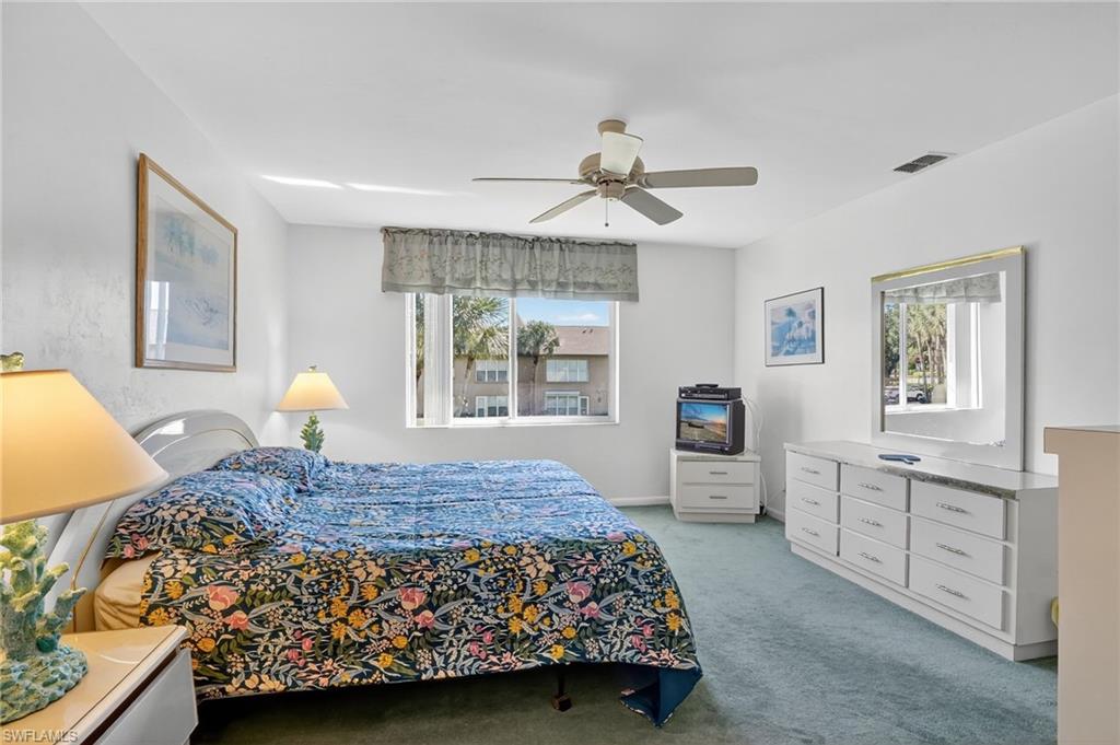 4210 Looking Glass Lane, Unit 4210 Naples, FL 34112 - Photo 17 of 20 a bedroom with a large bed and a window