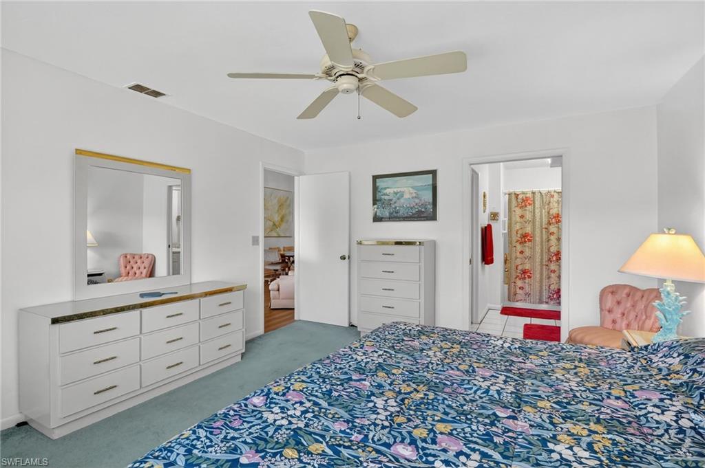 4210 Looking Glass Lane, Unit 4210 Naples, FL 34112 - Photo 18 of 20 a bedroom with a bed and a dresser