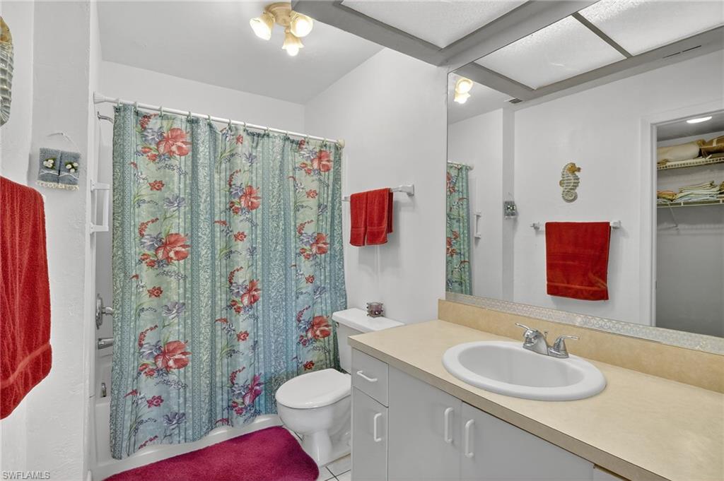 4210 Looking Glass Lane, Unit 4210 Naples, FL 34112 - Photo 19 of 20 a bathroom with a sink toilet and shower