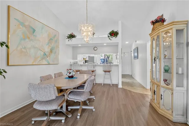 a view of a dining room with furniture wooden floor and a chandelier