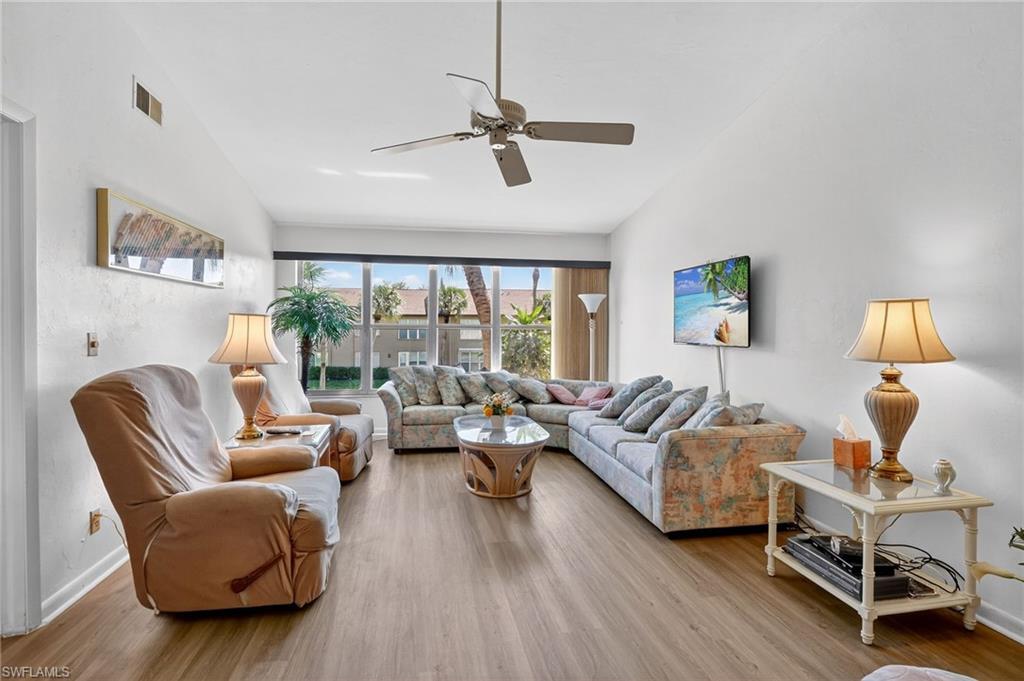 4210 Looking Glass Lane, Unit 4210 Naples, FL 34112 - Photo 9 of 20 a living room with furniture and a window