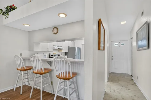 a view of kitchen with cabinets and wooden floor