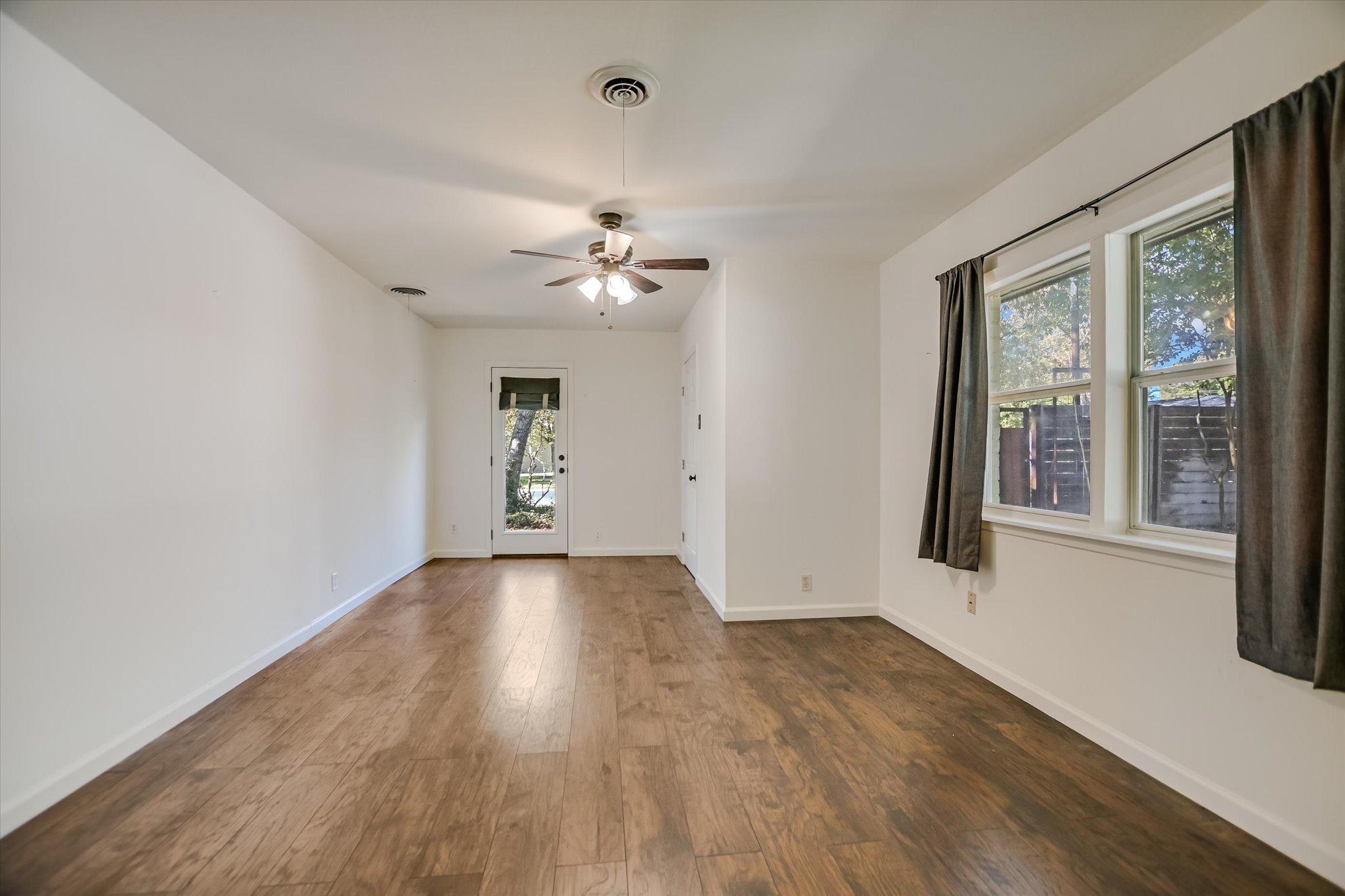 1601 East 19th Street Georgetown, TX 78626 - Photo 13 of 31 a view of an empty room with a window and wooden floor