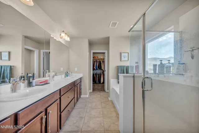 a bathroom with a double vanity sink and a mirror