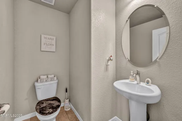 a bathroom with a sink toilet and a mirror