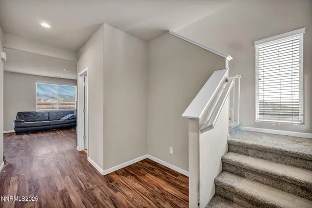 a view of a livingroom with furniture and stairs