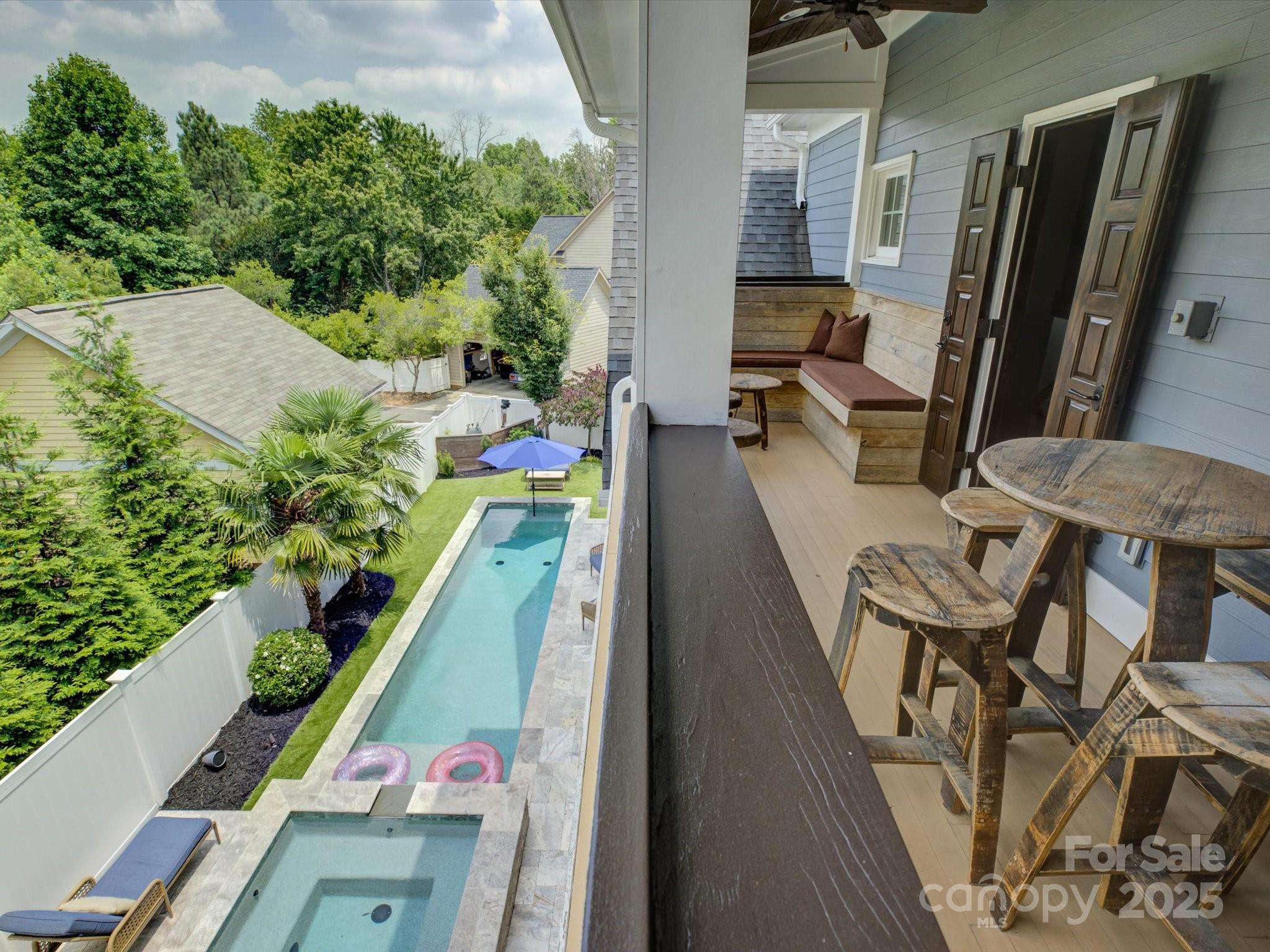 an aerial view of a balcony with chairs