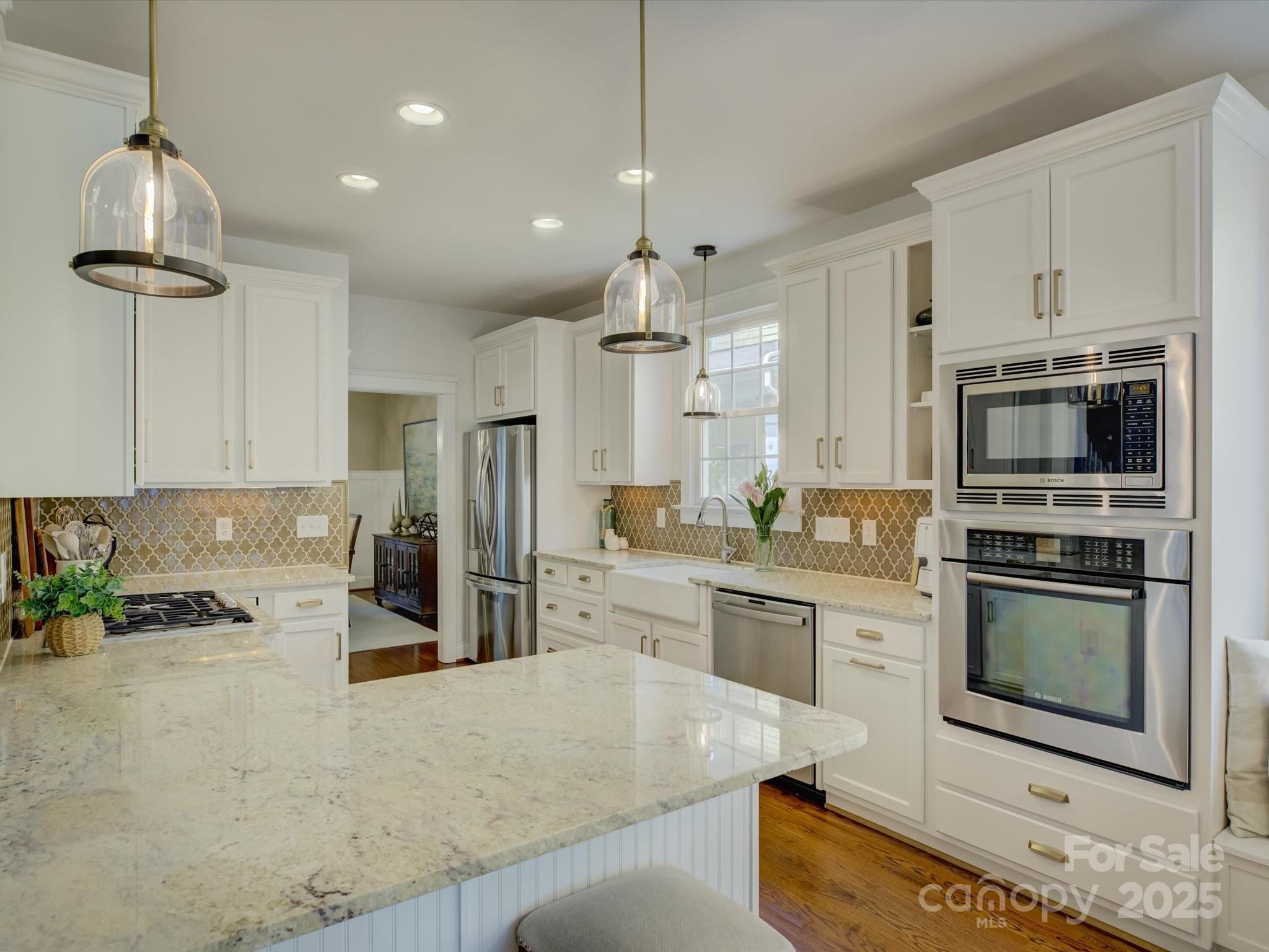 628 Bracket Street Fort Mill, SC 29708 - Photo 12 of 48 a kitchen with stainless steel appliances granite countertop a stove refrigerator and microwave