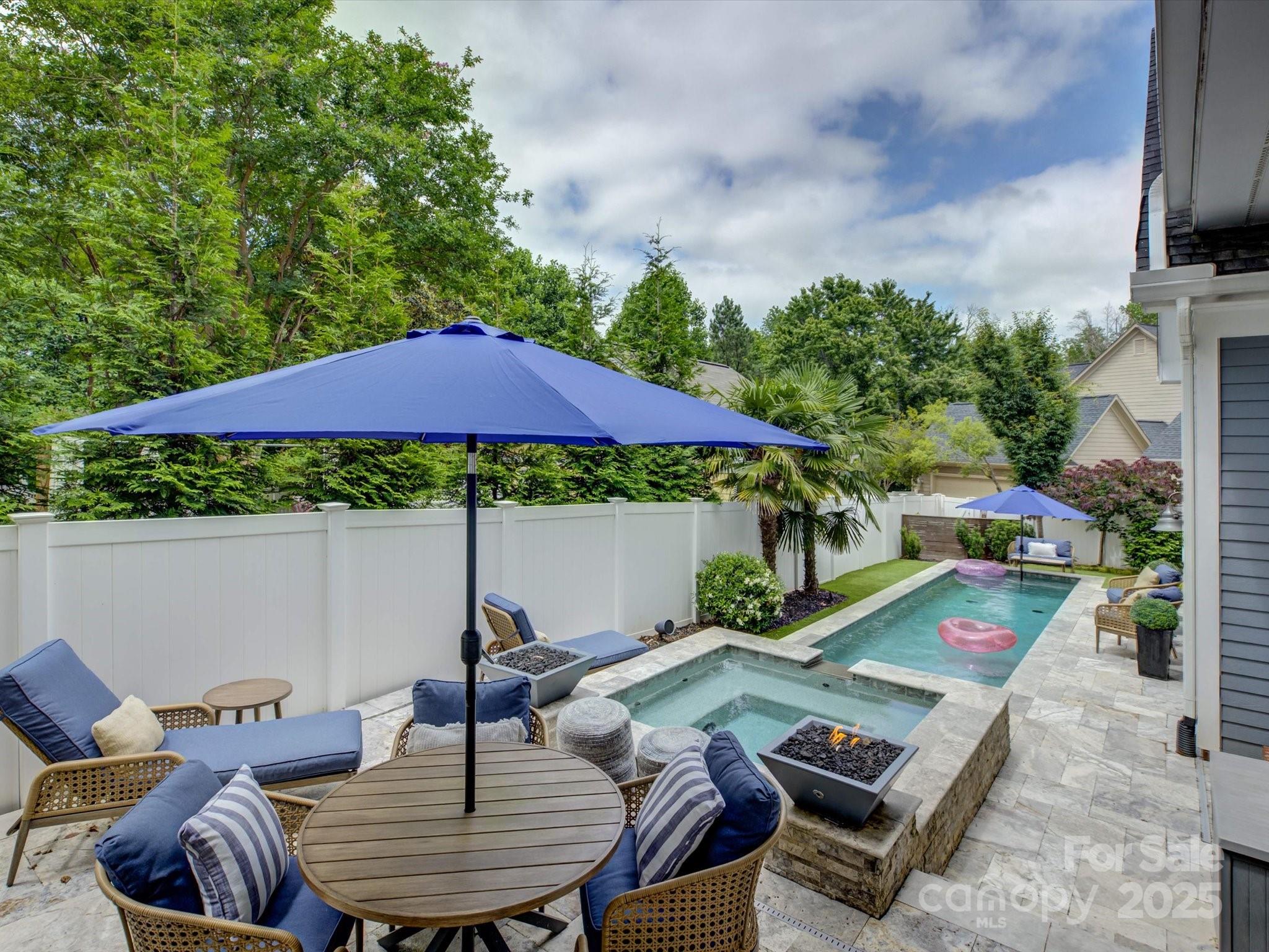 628 Bracket Street Fort Mill, SC 29708 - Photo 2 of 48 a view of a patio with furniture and table under an umbrella