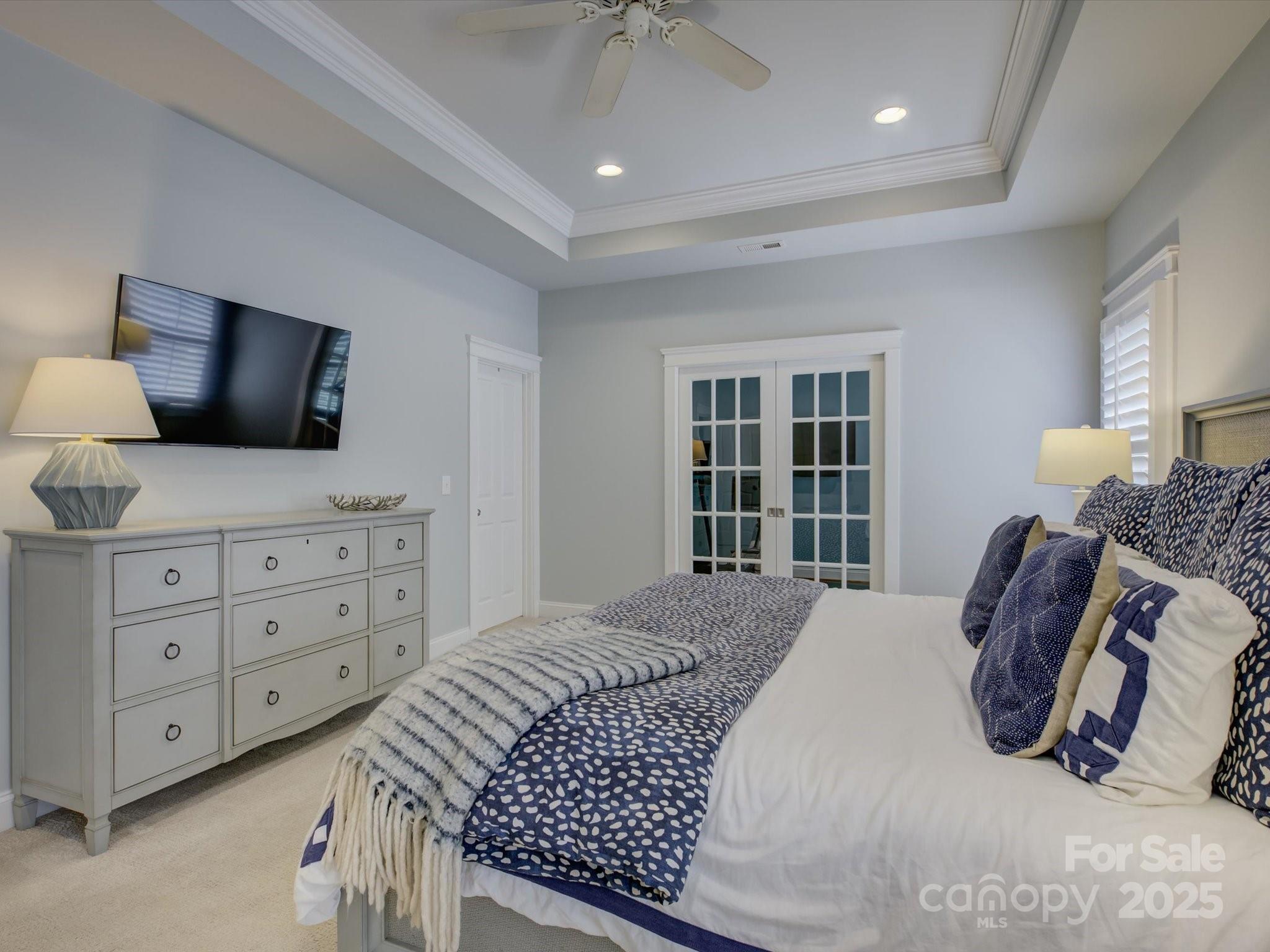 628 Bracket Street Fort Mill, SC 29708 - Photo 23 of 48 a bedroom with a large bed and a flat tv screen on dresser
