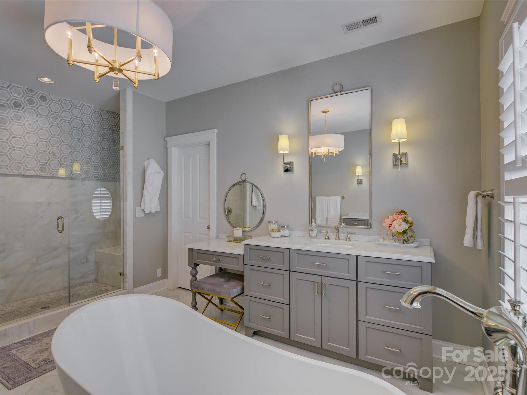 628 Bracket Street Fort Mill, SC 29708 - Photo 25 of 48 a bathroom with a sink a mirror and a shower