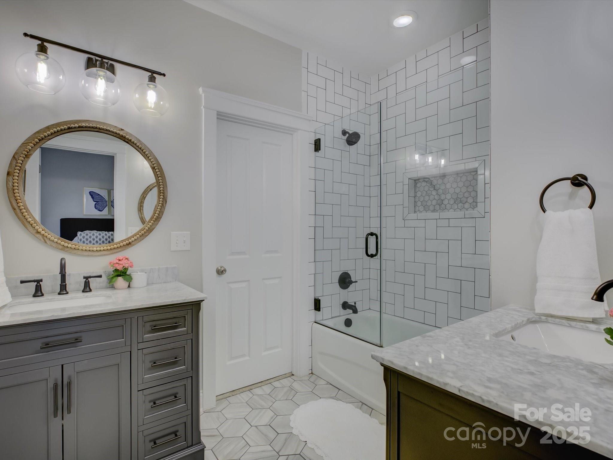 628 Bracket Street Fort Mill, SC 29708 - Photo 29 of 48 a bathroom with a granite countertop sink a mirror and shower