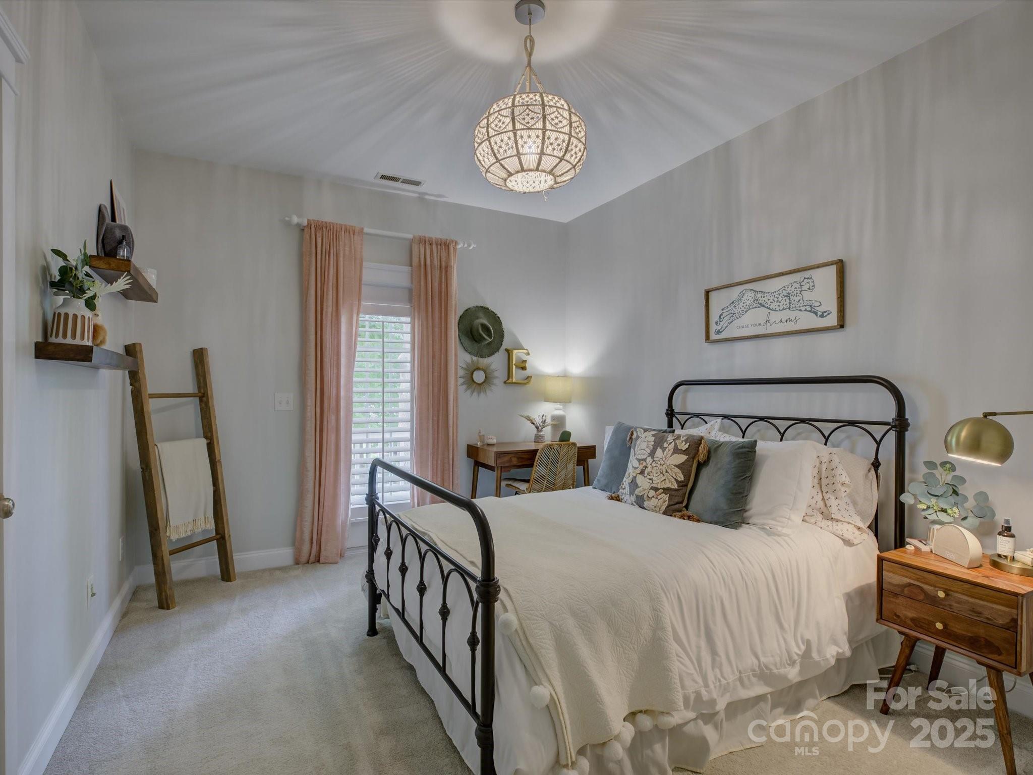 628 Bracket Street Fort Mill, SC 29708 - Photo 30 of 48 a bedroom with a bed and a chandelier