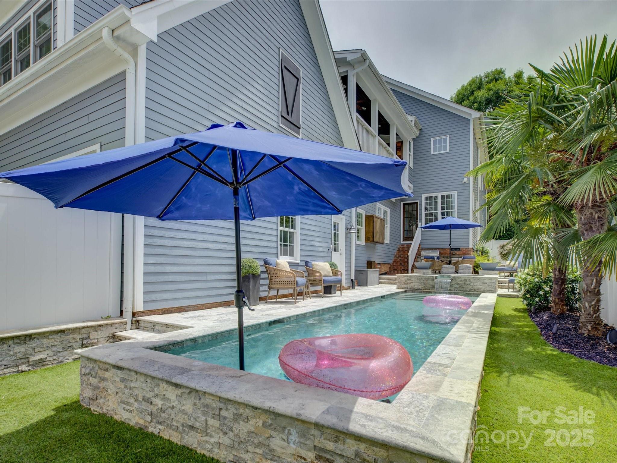 628 Bracket Street Fort Mill, SC 29708 - Photo 46 of 48 a patio with a table and chairs under an umbrella