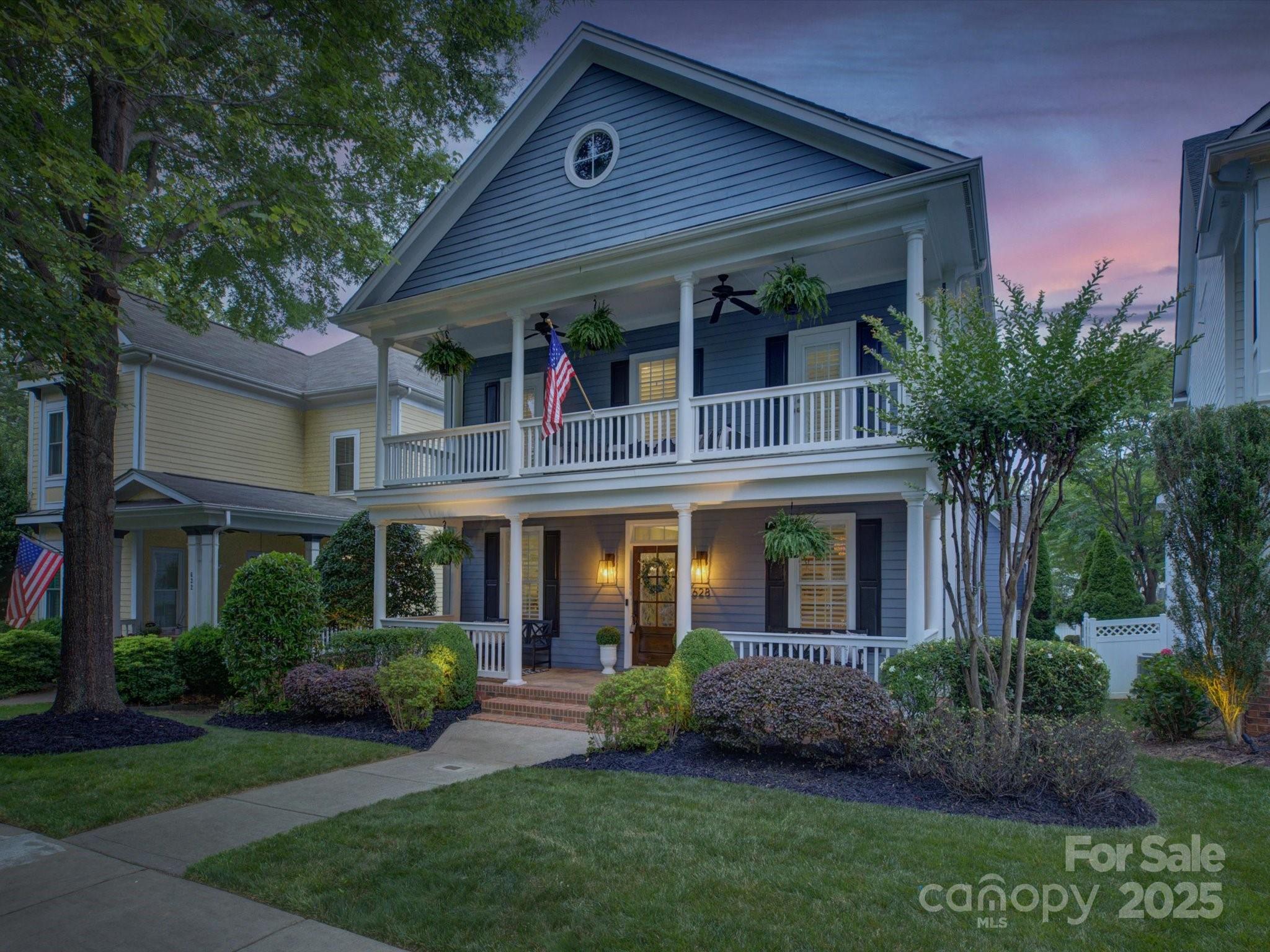 628 Bracket Street Fort Mill, SC 29708 - Photo 48 of 48 a view of a brick house with a large windows and a yard with plants and large trees