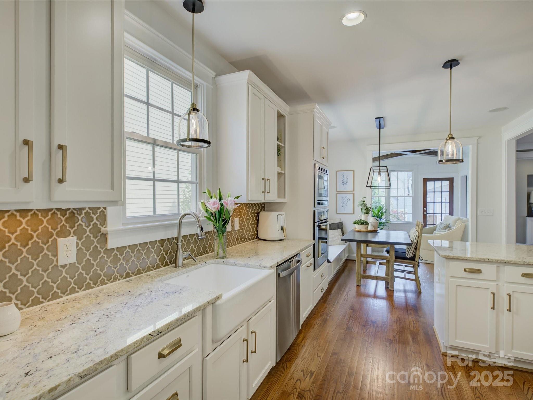 628 Bracket Street Fort Mill, SC 29708 - Photo 9 of 48 a large kitchen with granite countertop a lot of counter space and wooden floor