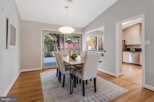 a kitchen with stainless steel appliances granite countertop a stove a sink and white cabinets