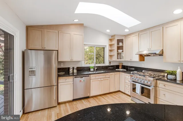 a kitchen with a refrigerator and a sink