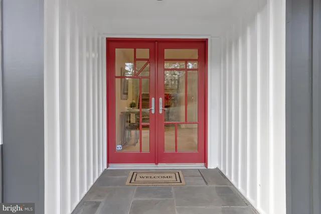 a view of an entryway with wooden floor and windows