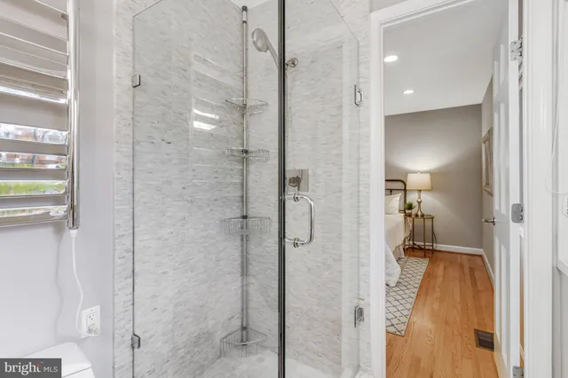 a living room with furniture cabinets and a window