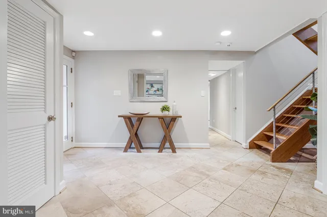 a living room with furniture a fireplace and a large window