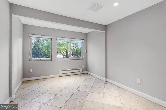 a view of a patio with table and chairs and wooden floor