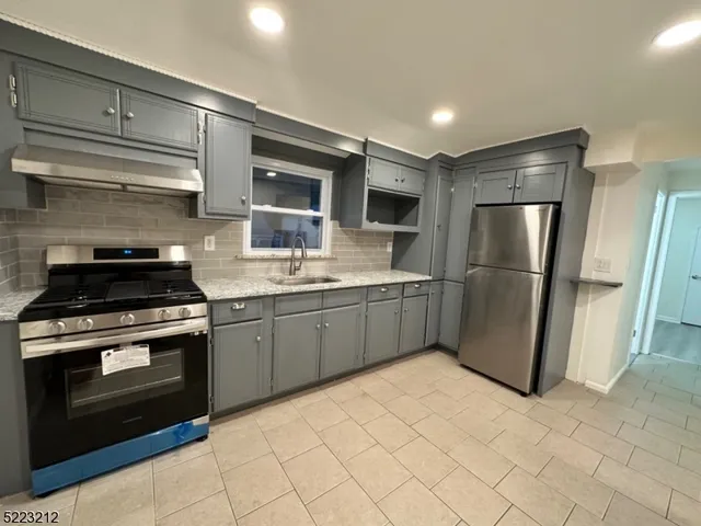 a kitchen with a stove sink and refrigerator