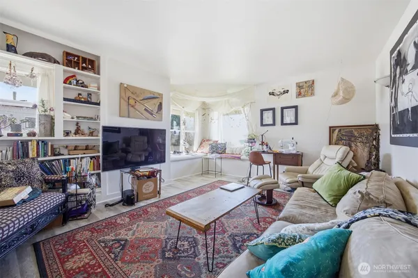 a living room with furniture a rug and a fireplace