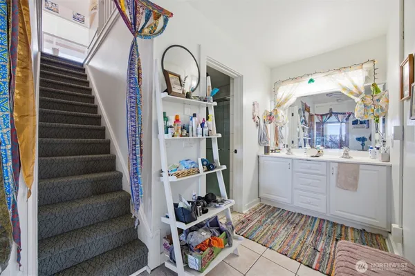 a living room with furniture a rug and white walls